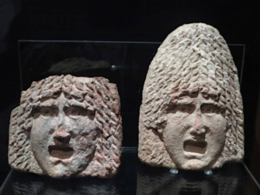 Ancient bas-reliefs with faces from the archaeological museum in Aguilas