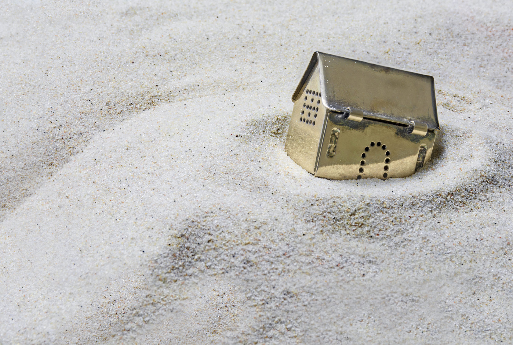 Toy house in sand