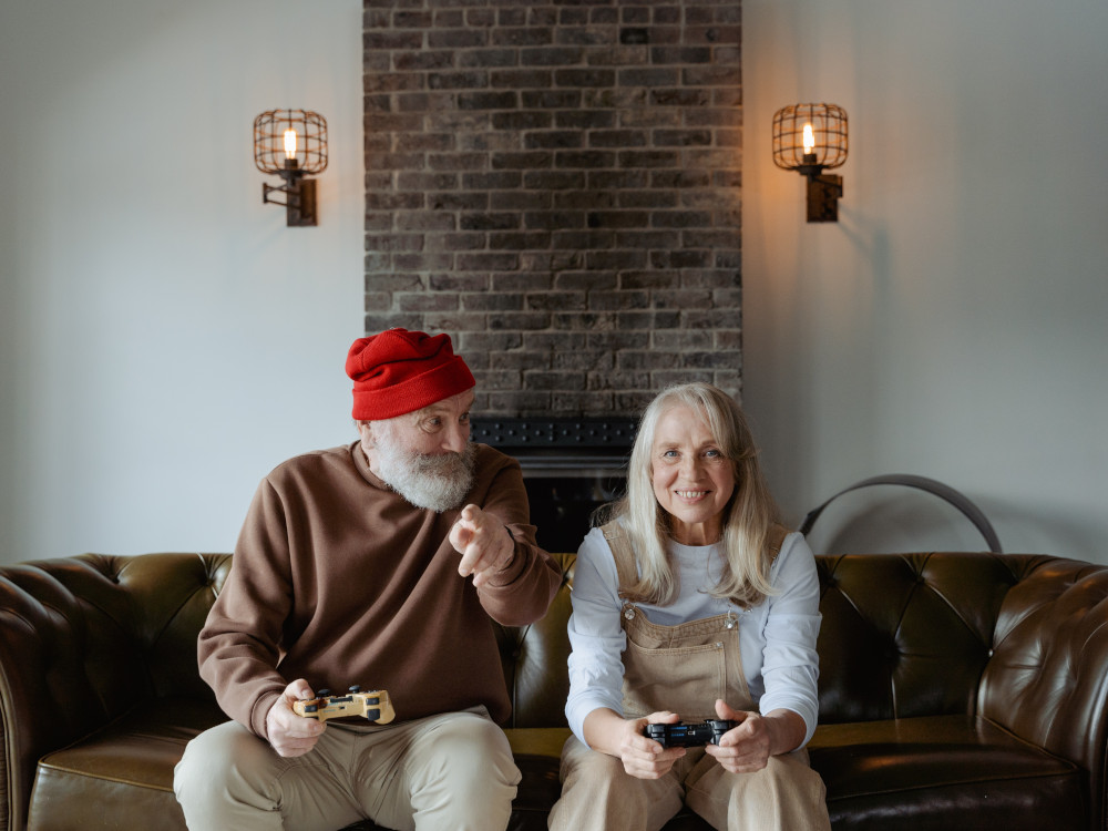 elderly man and elderly woman playing video games